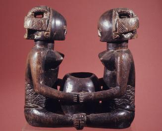 Two Female Figures Holding Bowl Between Them
