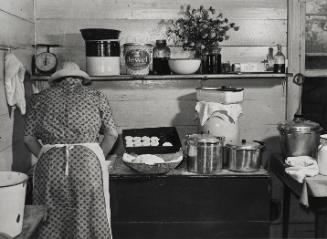 Untitled (One of the Wilkins family making biscuits for dinner on cornshucking day at Mrs. Fred Wilkins' home near Tallyho, Granville County, North Carolina)