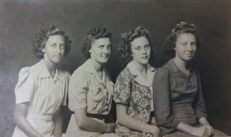 Untitled [four seated women in dresses]