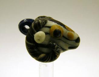 Bead in the form of a ram's head