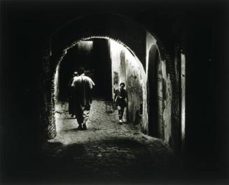 Woman Walking through Dark Passage