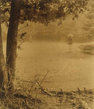 Woman with Hat Walking Through Clearing