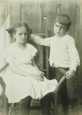 Young Boy and Young Girl in Chair