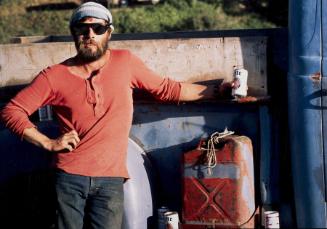 Trader by side of his pickup truck, Van Damme Beach, Mendocino, CA