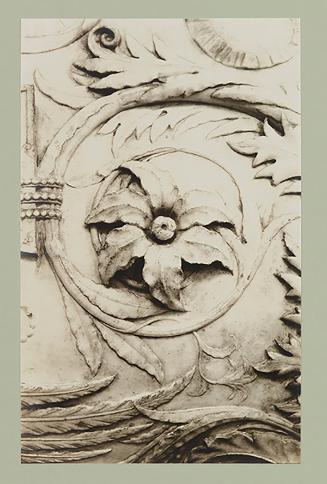 Urn; Foliage; Rosette to right of inscription