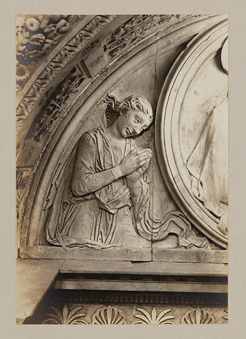 Adoring angel. relief, above head of bier