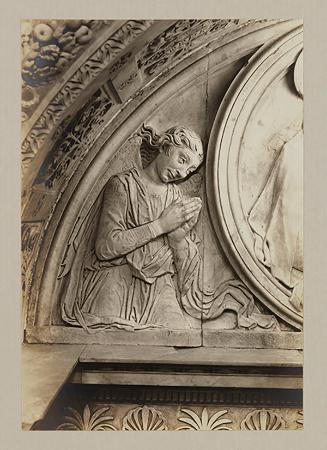 Adoring angel. relief, above head of bier
