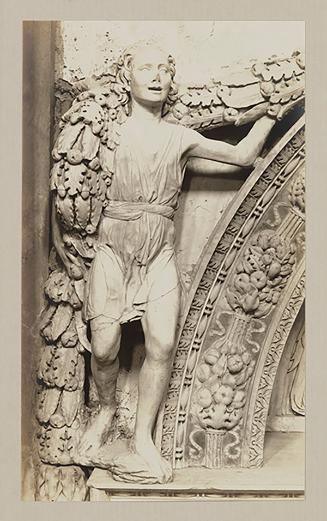 Youth bearing garland above head of bier