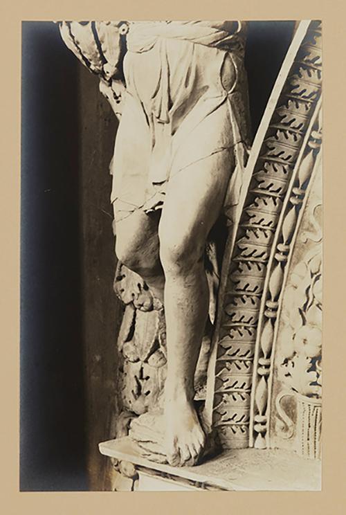 Youth bearing garland above head of bier; Legs, from the waist down