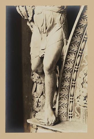 Youth bearing garland above head of bier; Legs, from the waist down