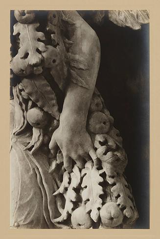 Youth bearing garland above foot of bier; His left arm (from the elbow) and hand