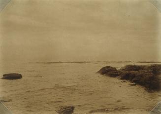 Small Waves Lapping Against Rocky Outcropping