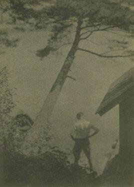 Man Near House with Leaning Tree