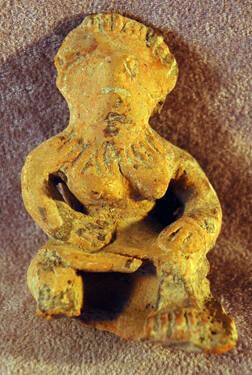 Seated female figure with hands on lap